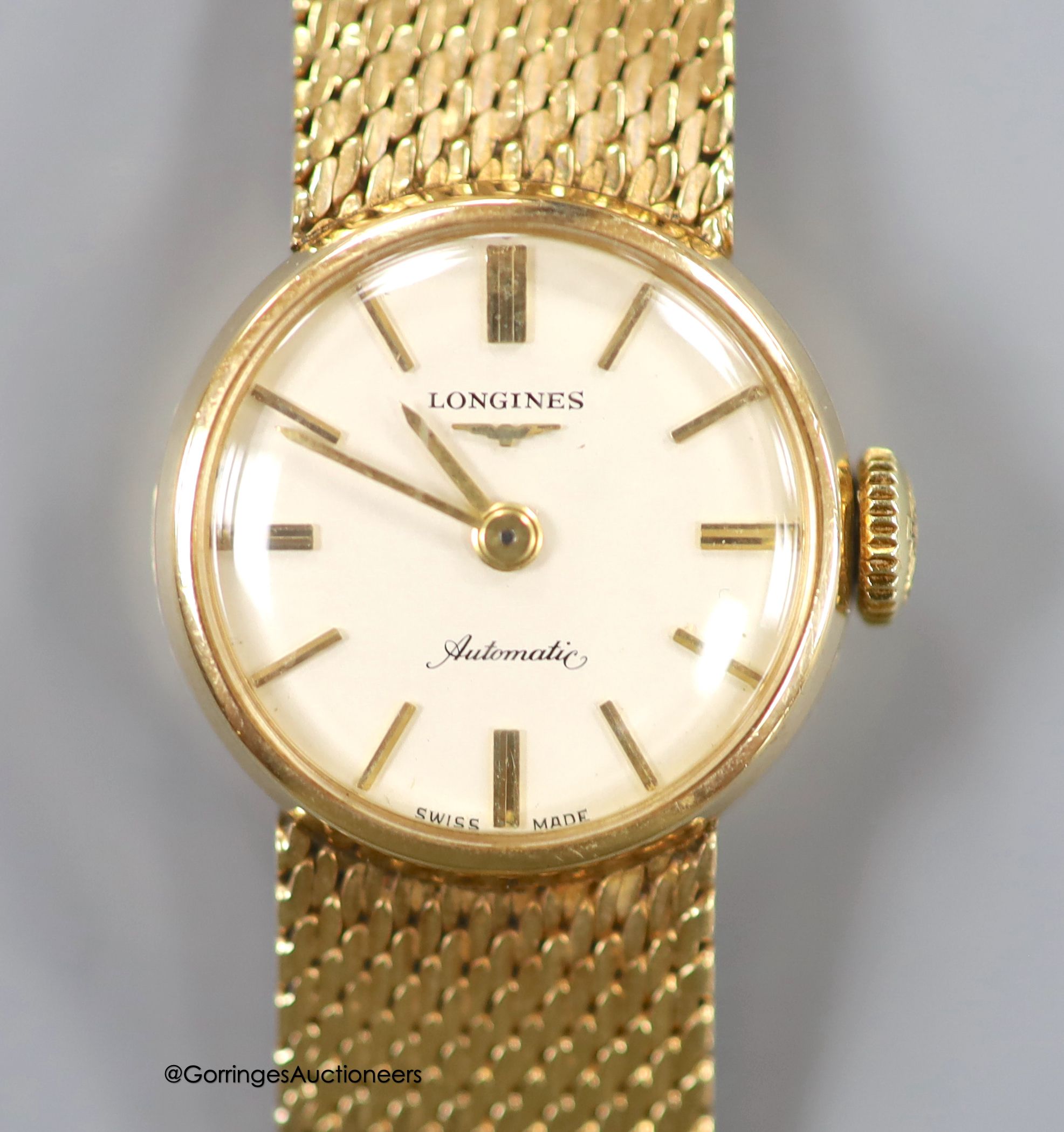 A lady's 9ct gold Longines manual wind wrist watch, on a 9ct gold bracelet, case diameter 20mm, gross weight 31.1 grams, in Longines box.